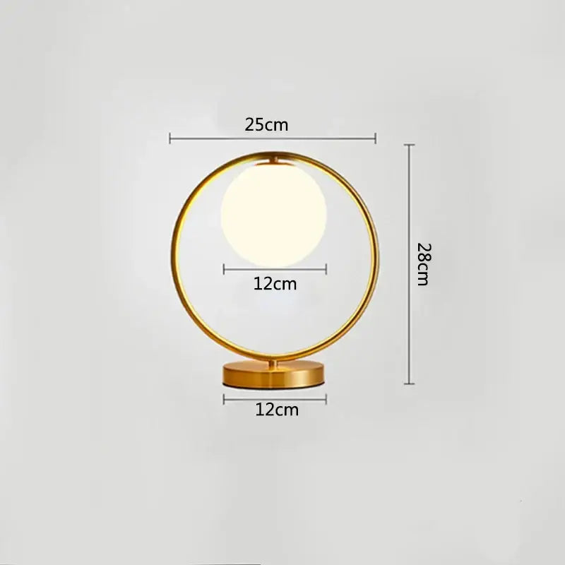 Modern brass glass led table lamp with gold-toned circular design and glowing bulb for bedroom reading decorbites brass glass