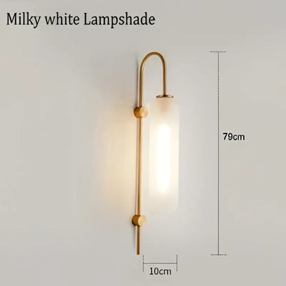 Modern brass glass sconce wall lamp with milky white glass lampshade and curved brass frame for living room wall lamp