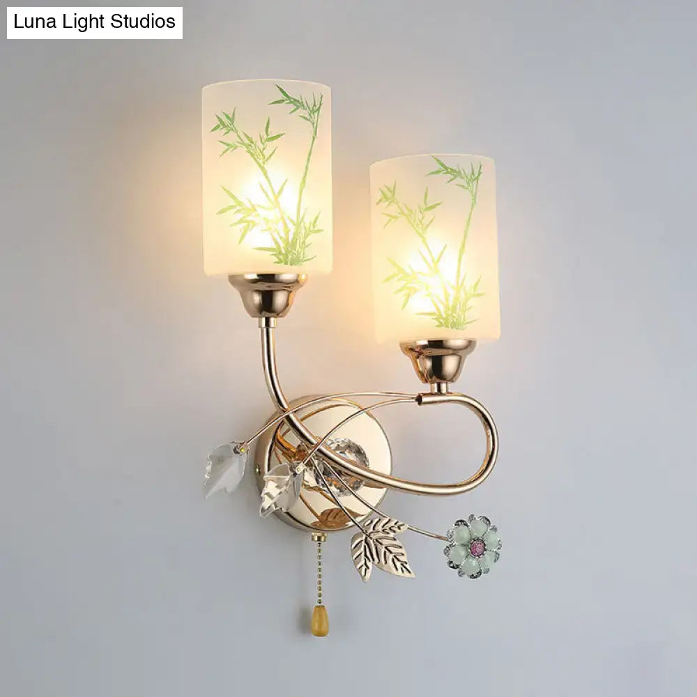 Modern brass wall lamp with glass shade, pull chain, frosted glass featuring green bamboo and crystal leaf accents