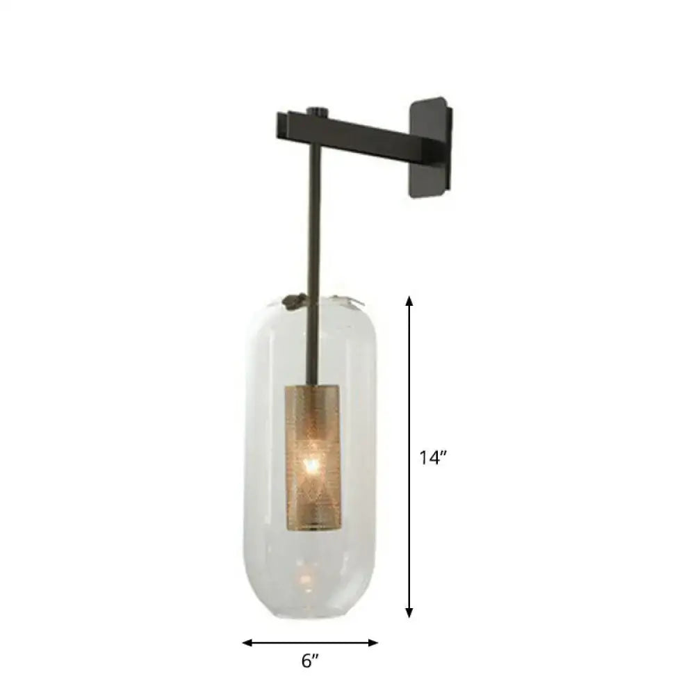 A sleek black metal wall sconce with clear glass cylinder and amber bulb featuring wire mesh guard 110v-120v