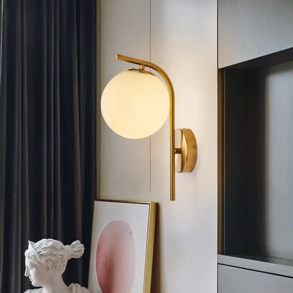 Modern brass bedside lamp with gold-toned inch fixture and frosted glass globe for bedroom lighting