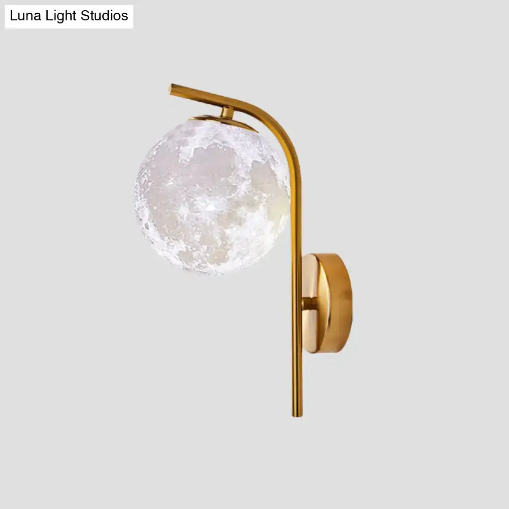 Modern brass bedside lamp wall sconce with a gold-toned inch fixture and frosted glass globe resembling the moon