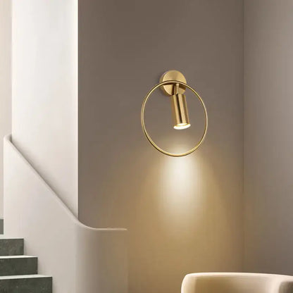 Modern brass gold adjustable led wall sconce with a sleek minimalist circular design for corridor lighting