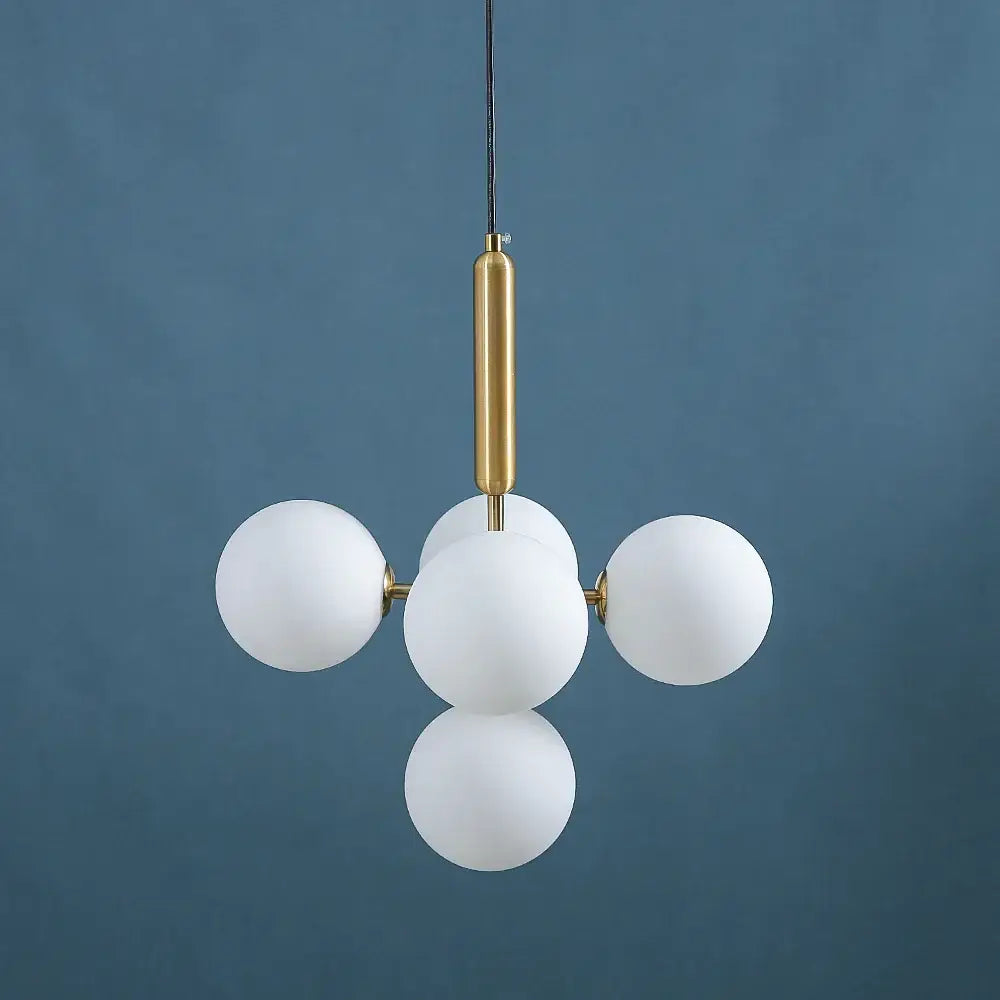 Modern brass golden glass balls ceiling light with five frosted white glass spheres on a polished brass rod for dining room decorbites ceiling light