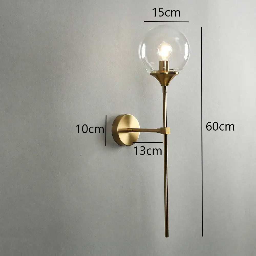 Modern brass golden glass wall sconces featuring a gold-toned metal body with clear glass globe and exposed bulb decorbites golden glass wall decor