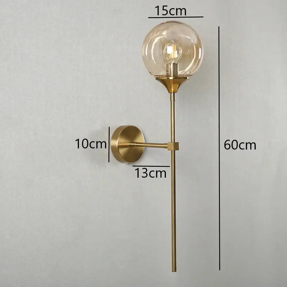 Modern brass golden glass wall sconces featuring a gold-toned globe with an exposed filament bulb for bedroom decorbites golden glass wall