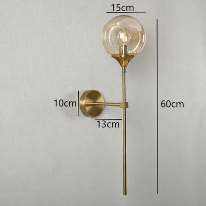 Modern brass golden glass wall sconces featuring a gold-toned globe with an exposed filament bulb for bedroom decorbites golden glass wall