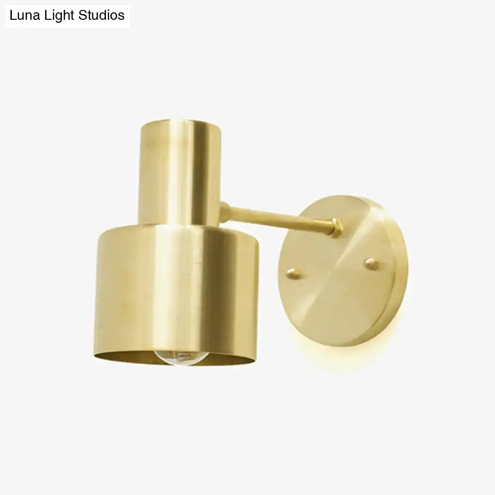 Modern brass grenade shade wall light with cylindrical shade and circular mounting plate for corridor use