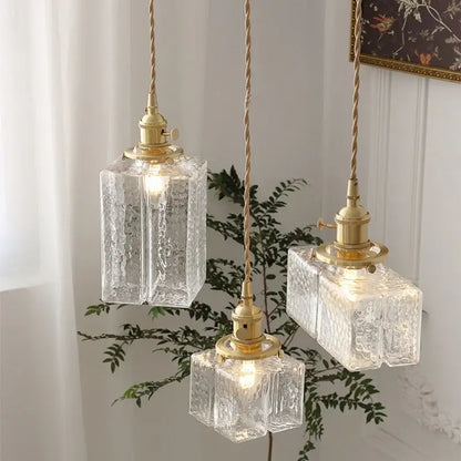 Modern brass ice cube glass pendant light with three clear textured glass shades and twisted cord suspensions for kitchen island decorbites pendant light