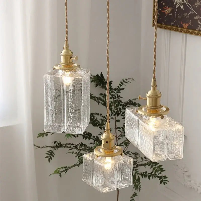Modern brass ice cube glass pendant light with three clear textured glass shades and twisted cord suspensions for kitchen island decorbites pendant light