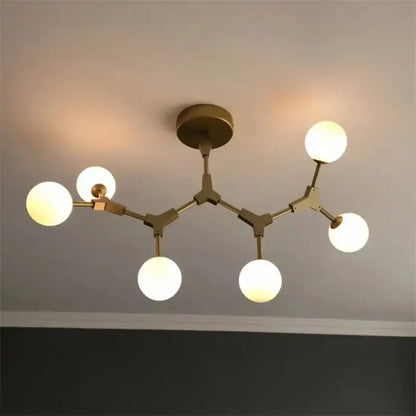 Modern brass iron magic molecular pendant lights with five glowing spherical glass bulbs for dining room decorbites design