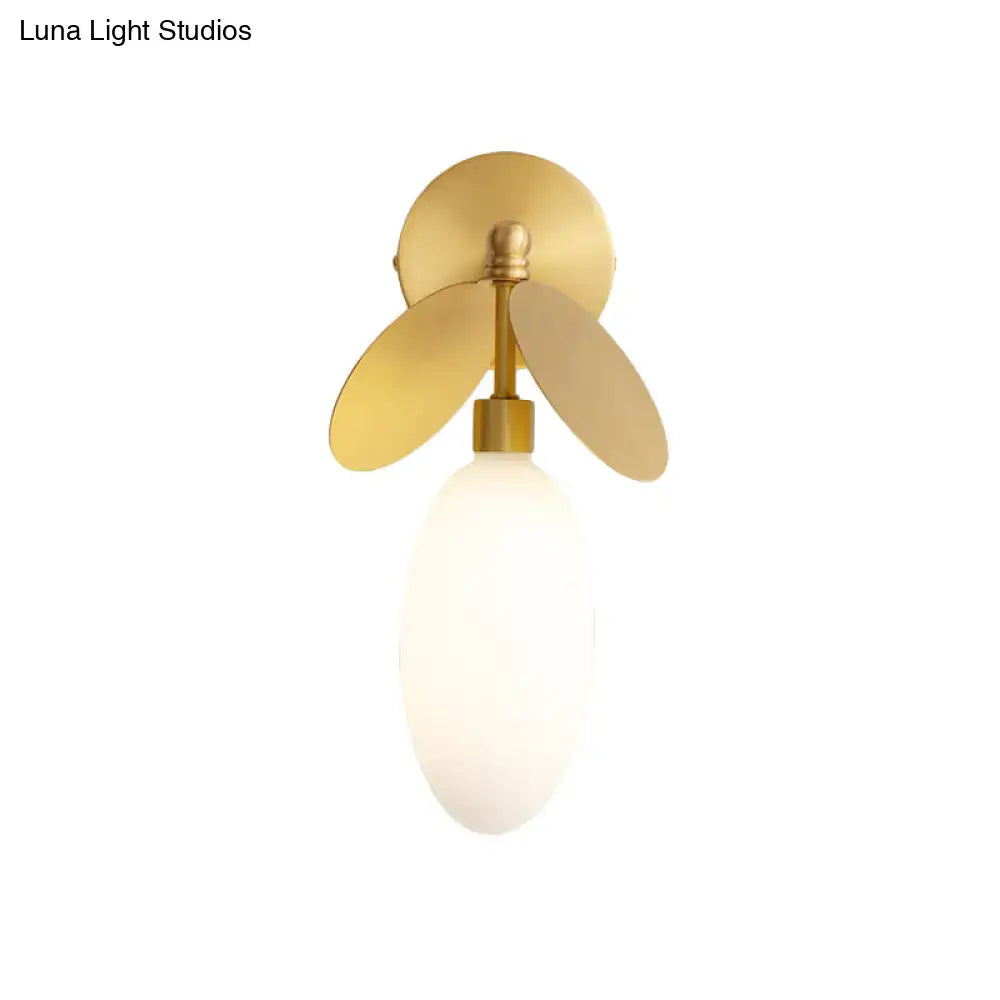 Modern brass leaf wall lamp with cream glass globe and gold-toned metal fins suitable for 220v-240v and 110v-120v use