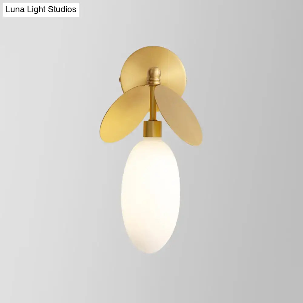 Modern brass leaf wall lamp with cream glass shade and gold-toned 220v-240v wall sconce featuring petal accents