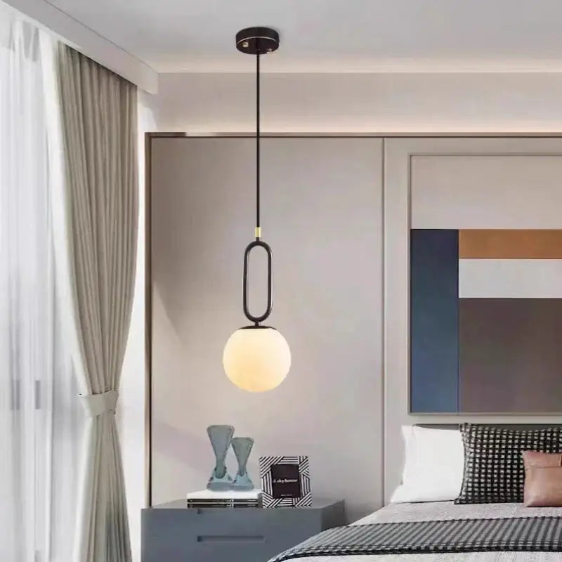 A modern black pendant light with a sleek oval metal frame and warm frosted glass globe from decorbites brass led pendant collection