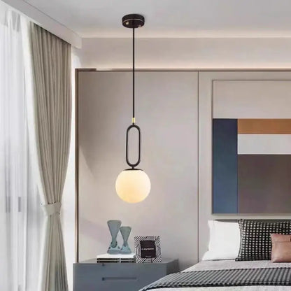 A modern black pendant light with a sleek oval metal frame and warm frosted glass globe from decorbites brass led pendant collection