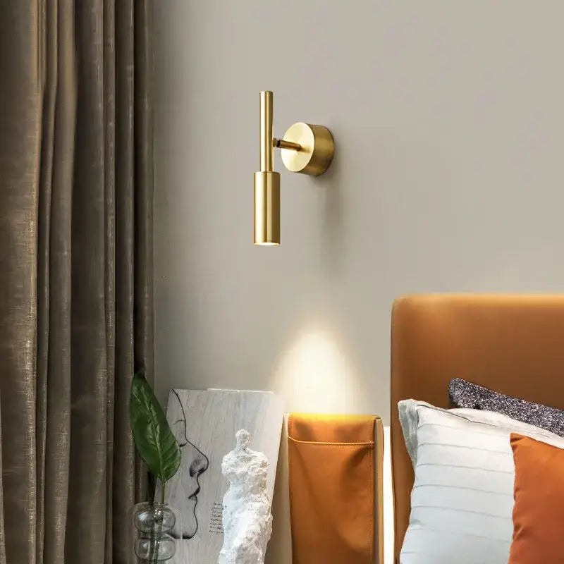 Modern brass led wall lamp with a gold-toned rotatable cylindrical sconce for stylish bedroom decorbites brass led lighting
