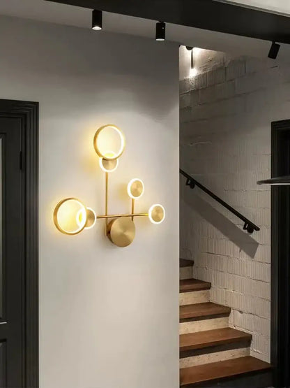 Modern brass led wall light featuring a gold-toned circular sconce with a branching design for living room decorbites brass led