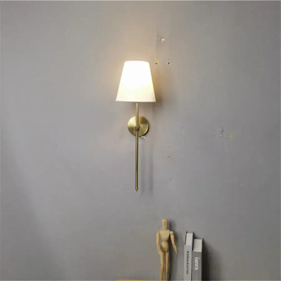 Modern brass led wall sconce with a soft white fabric shade ideal for bedroom decorbites led wall sconce design