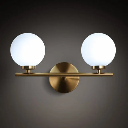 Modern brass light fixture with two frosted glass product shade globes for bedroom sconce lighting with product bulb