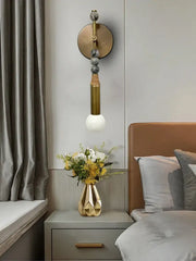 Modern brass marble ball wall sconce featuring a gold-toned geometric vase with a faceted angular design decorbites brass marble decor