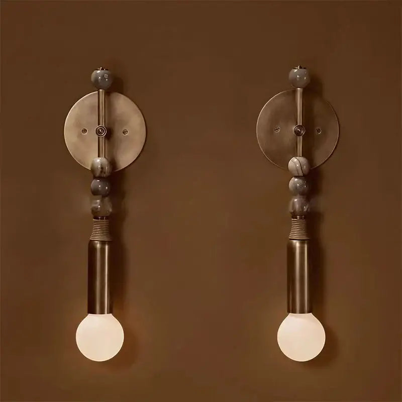 Pair of modern wall sconces with brushed brass fixtures gray marble beads and frosted glass bulbs brass marble ball decorbites