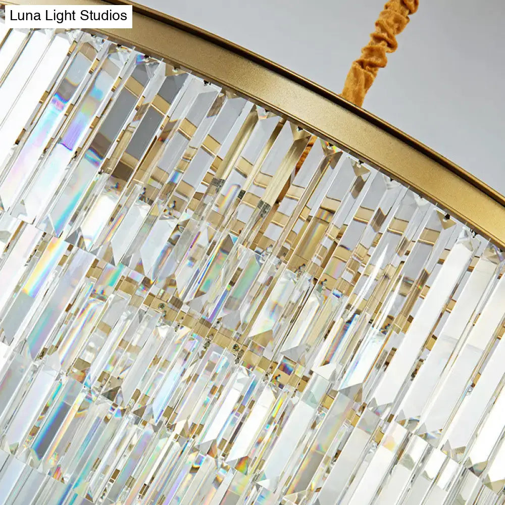Modern brass oval crystal chandelier with cascading clear prisms gold-toned metal frame for dining room hanging light