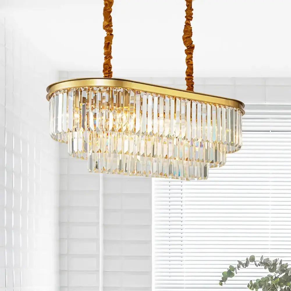 Modern brass oval crystal chandelier with gold finish and cascading prisms for elegant dining room hanging light