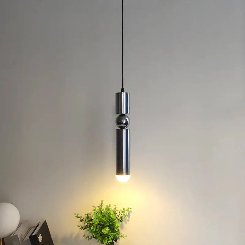 Modern chrome pendant light with sleek cylindrical design and central sphere as a decorbites brass pendant light alternative