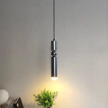 Modern chrome pendant light with sleek cylindrical design and central sphere as a decorbites brass pendant light alternative