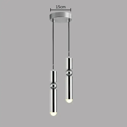 Modern chrome finished pendant light with two cylindrical bulbs and black cords in decorbites brass pendant light style
