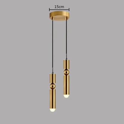 Modern brass pendant light with gold-toned cylindrical shades and spherical accents by decorbites for kitchen decor