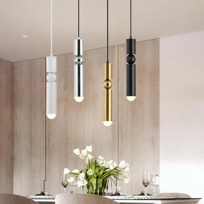 Modern brass pendant light with white, chrome, gold, and black cylindrical bodies and spherical accents for kitchen decorbites brass pendant