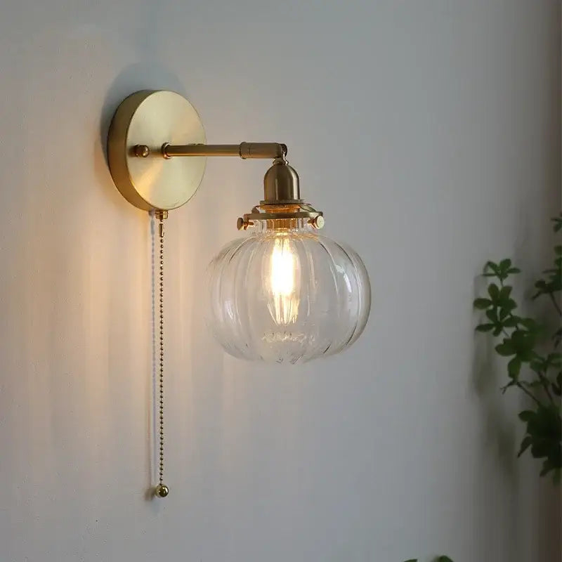 Modern brass ribbed glass ball wall sconce with clear globe and exposed filament bulb for elegant bedroom decorbites glass ball lighting
