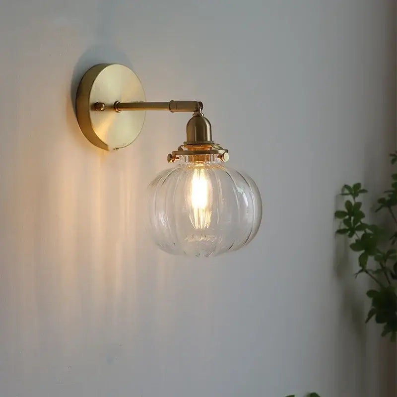 Modern brass ribbed glass ball wall sconce with clear glass globe and illuminated bulb for bedroom decorbites glass ball lighting