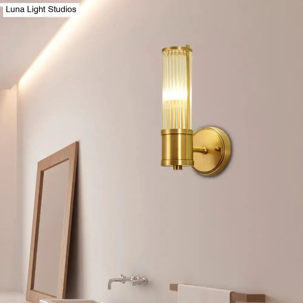 Modern brass ridged crystal wall light with gold-toned cylindrical glass shade featuring vertical ridges and fixture height detail