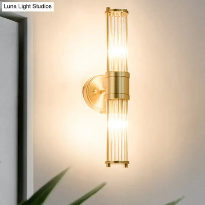 Modern brass ridged crystal wall light with gold-toned vertical glass rods and sleek light fixture height for hallways