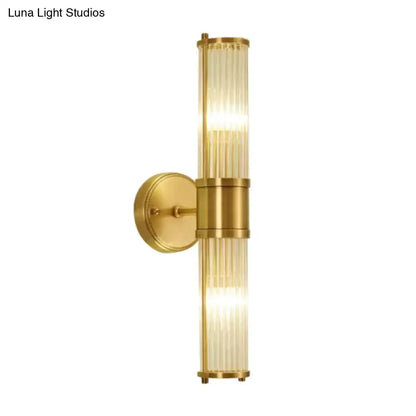 Modern brass ridged crystal wall light with gold-toned vertical ribbed glass panels and sleek fixture height design