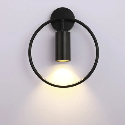 Black circular modern brass ring led wall lamp with matte finish and warm focused light for bedroom sconce