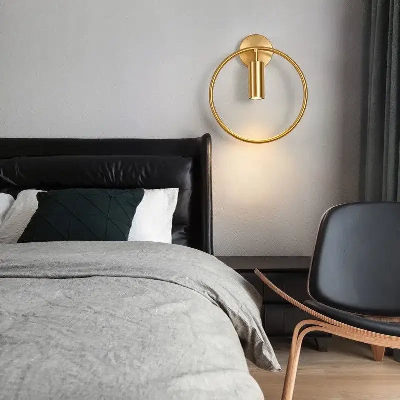 Gold-toned modern brass ring led wall lamp with a sleek minimalist design for bedroom wall lamp lighting