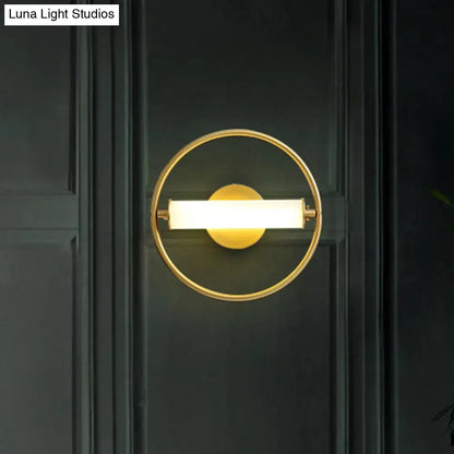 Modern brass ring wall sconce with gold-toned finish featuring an illuminated rectangular light bar and opal glass shade