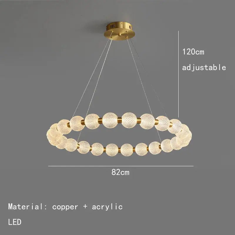 Modern brass round led pendant lights feature a gold-toned double-ring chandelier with textured acrylic spheres and copper accents