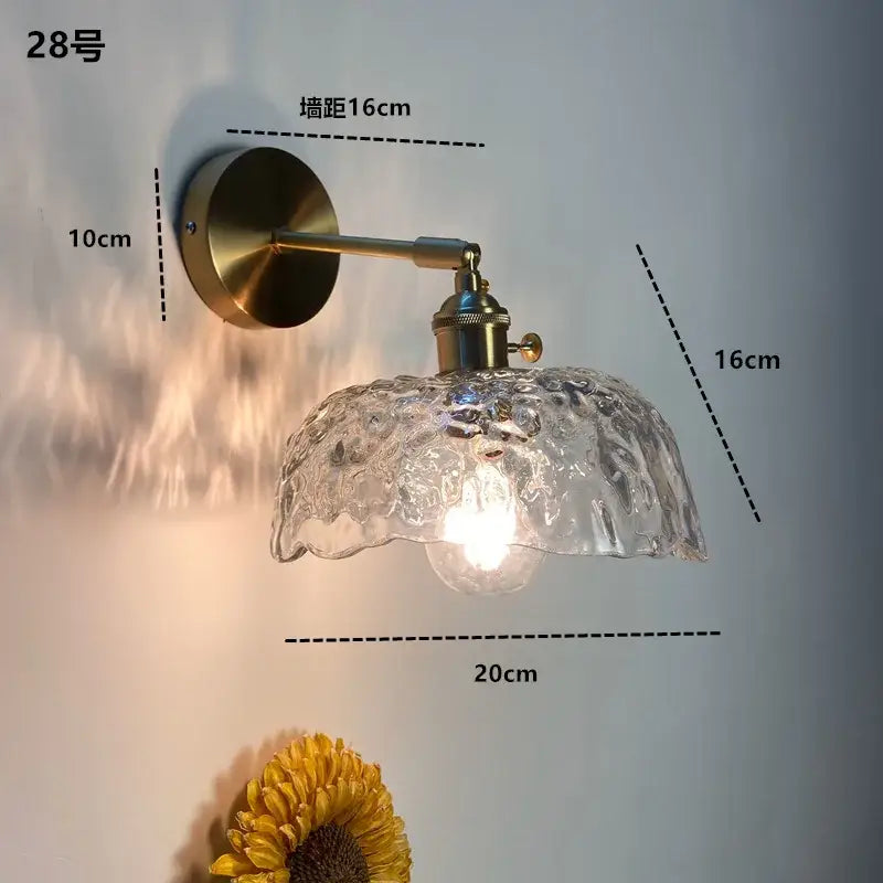 Antique brass-finished wall sconce with decorbites clear glass led ruffled shade for modern bathroom lighting
