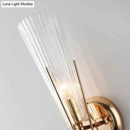 Modern brass sconce light with sleek gold tone and clear crystal ribbed glass shade for e12 e14 bulbs in bedroom use