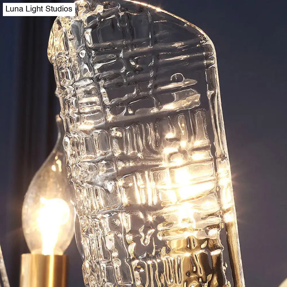 Modern brass sconce with clear water glass shades featuring textured crocodile pattern and warm light for living room two lights