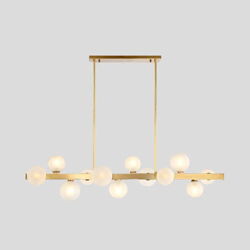 Modern brass simplicity globe pendant dining room light with gold-toned frame and frosted glass globe bulbs in linear design