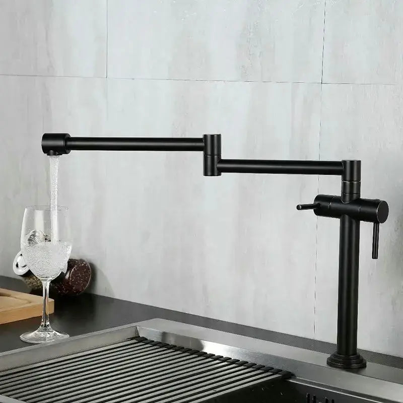 Modern brass single handle kitchen faucet with black matte finish and extendable articulated mixer tap design