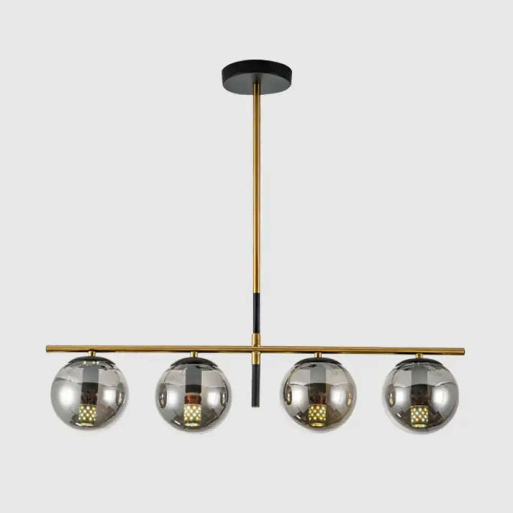 Modern brass and smoke grey globe chandelier with four reflective chrome shades for kitchen island lighting