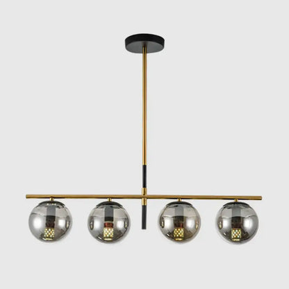 Modern brass and smoke grey globe chandelier with four reflective chrome shades for kitchen island lighting