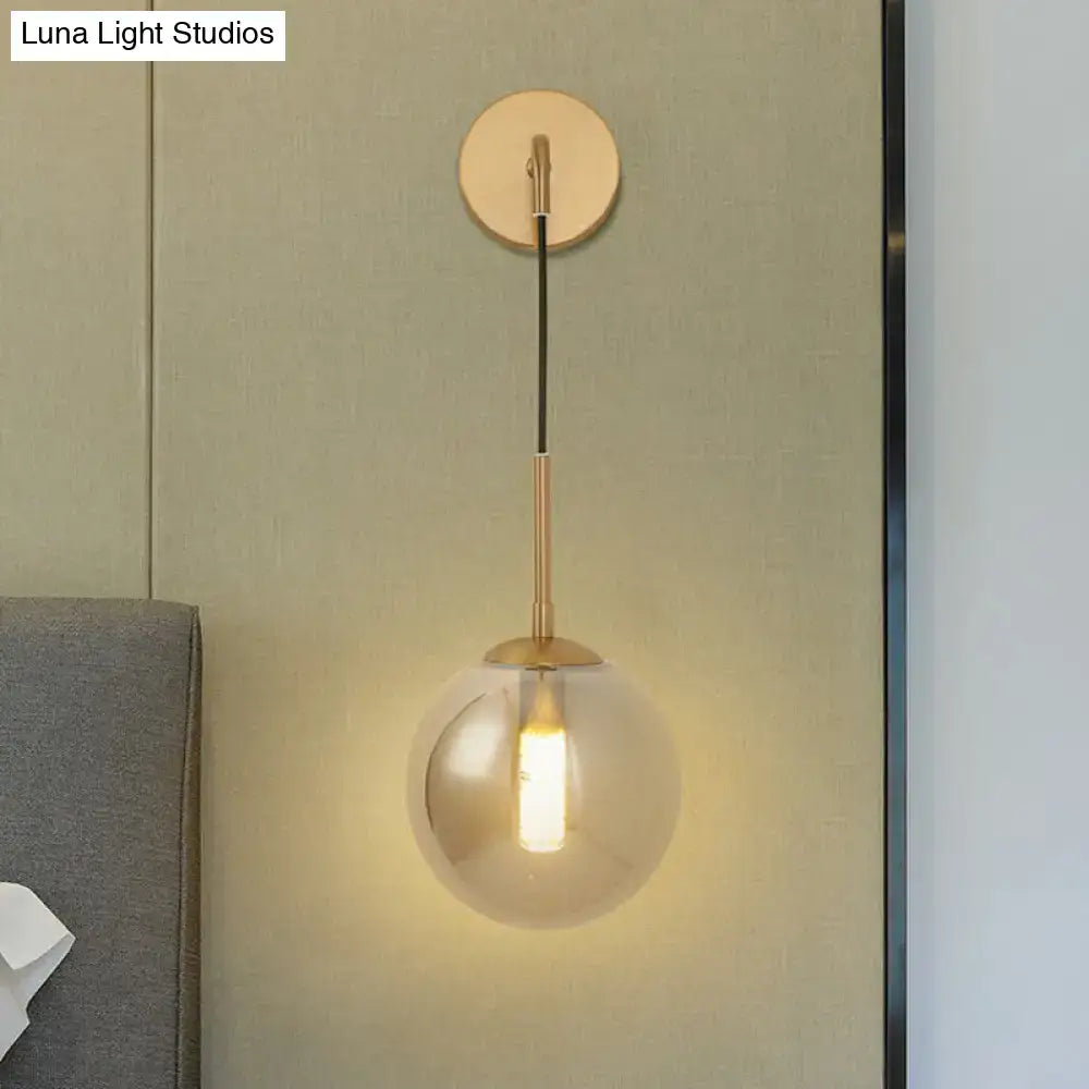 Modern brass smoked glass ball wall hanging lamp with gold-toned spherical glass ball wall and frosted finish