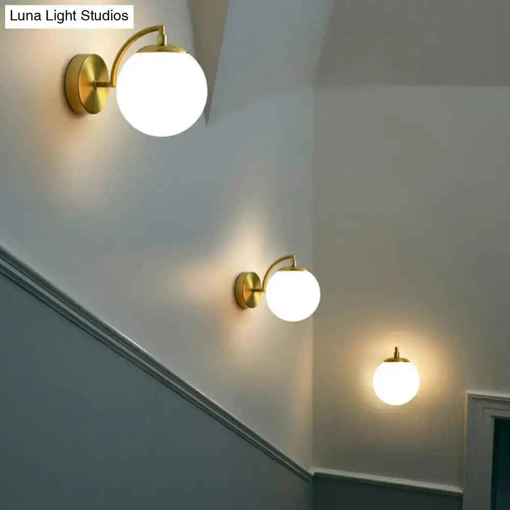 Modern brass stairway wall lighting fixture with gold finish and spherical frosted glass globe for e26 e27 bulb use